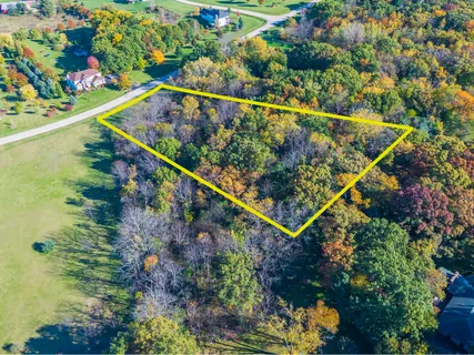 an aerial view of a houses with a lake view