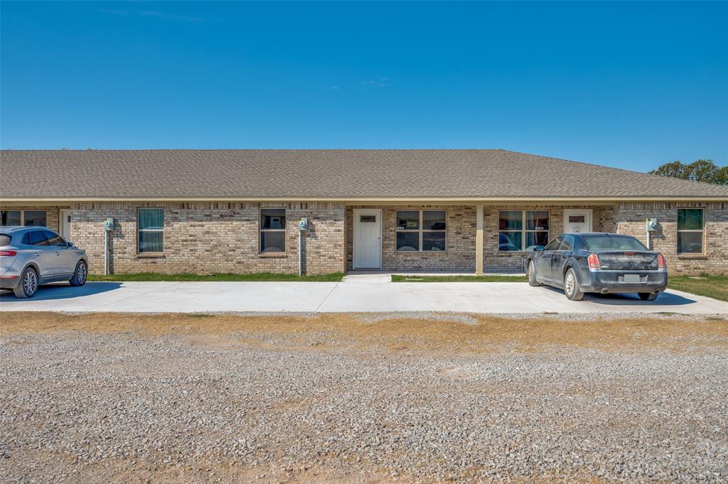 19161-19175 Cabo Way, Unit 19167 Thackerville, OK 73459 - Photo 22 of 25 a front view of a house with a garden and patio