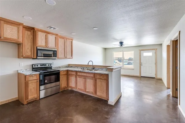 a kitchen with stainless steel appliances granite countertop a stove and a sink