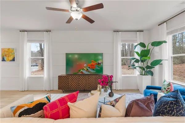a living room with furniture flowerpot and a window