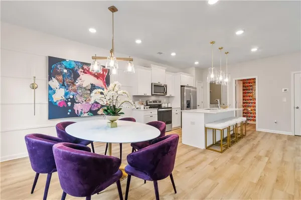 a view of a dining room with furniture kitchen and wooden floor