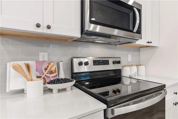 a stove top oven sitting inside of a kitchen