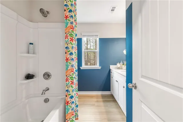 a view of a hallway to a house and wooden floor