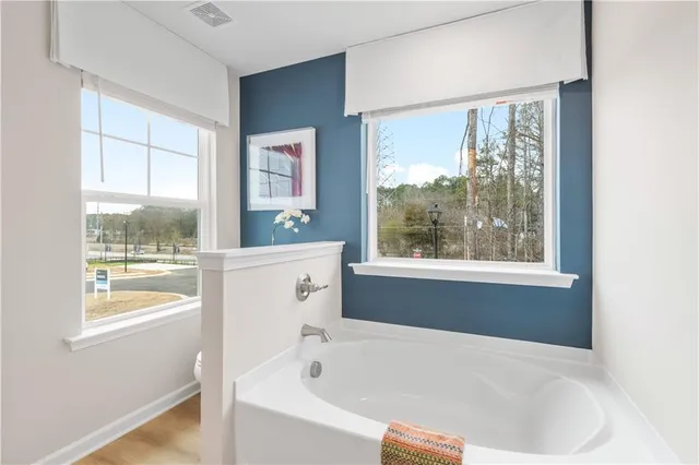 a white bath tub sitting next to a window