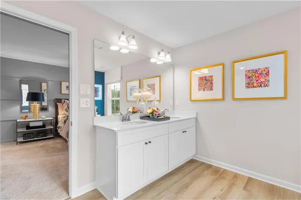a bathroom with a sink vanity and shower