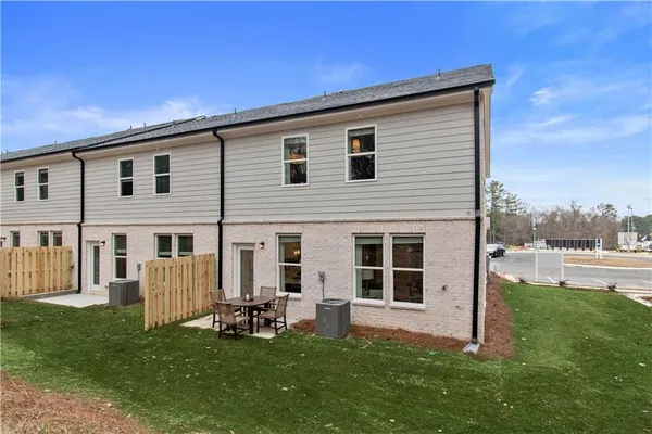 a view of a house with backyard and porch