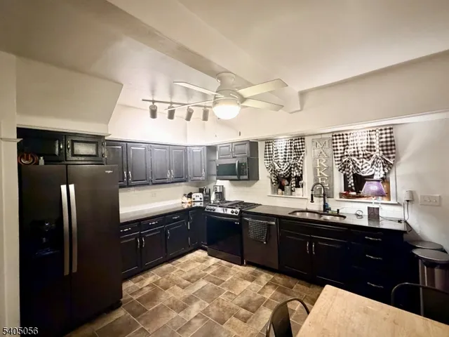 a bedroom with a bed dresser and flat screen tv