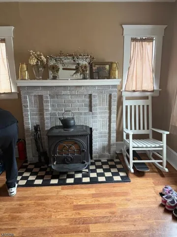 a living room with furniture a fireplace and a window