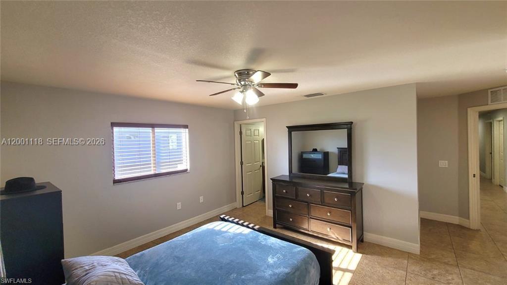 152 Pullman Street, Unit 152 Lehigh Acres, FL 33974 - Photo 11 of 15 a bedroom with a bed and a chandelier