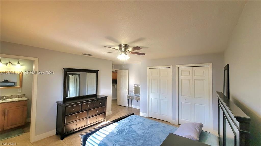 152 Pullman Street, Unit 152 Lehigh Acres, FL 33974 - Photo 10 of 15 a living room with furniture and a flat screen tv