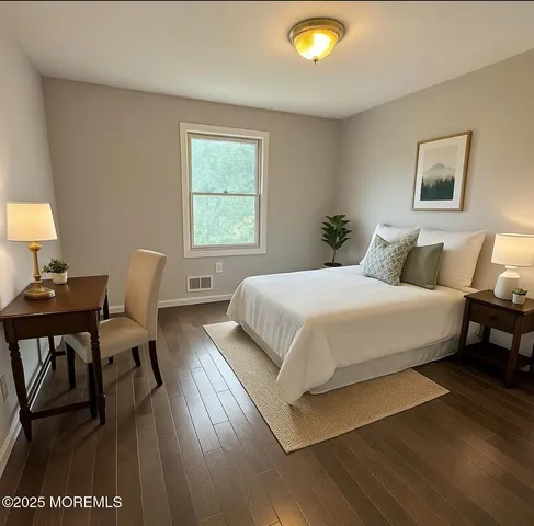 a bedroom with a bed and a lamp next to a window