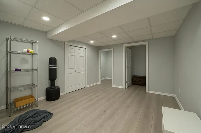 a hallway with a door and wooden floor