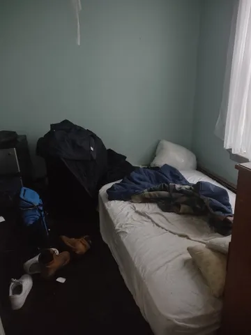 a bed sitting in a bedroom next to a window
