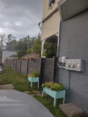 a view of a chair and table in backyard of the house