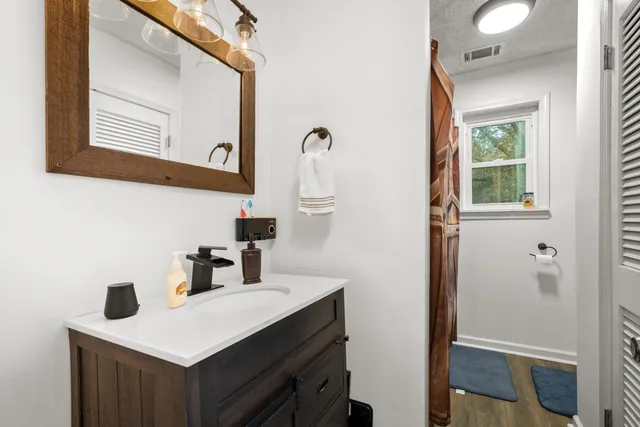 a bathroom with a sink vanity and a mirror