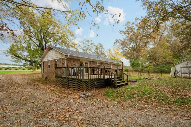 a view of a house with a yard a sitting area