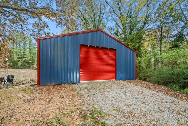 a view of a house with a backyard