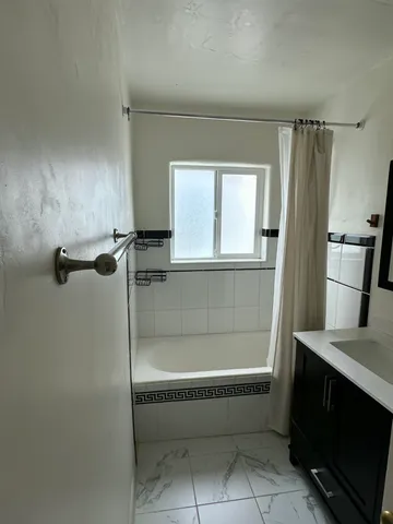a bathroom with a tub and a sink
