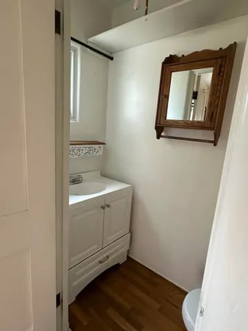 a bathroom with a toilet and a mirror