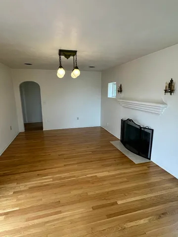 a view of empty room with a fireplace
