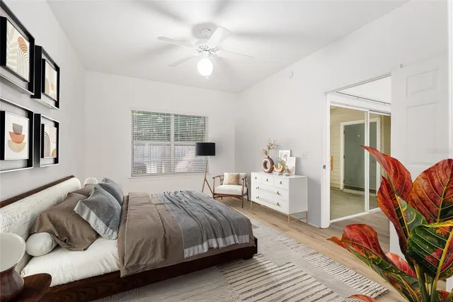 a spacious bedroom with a bed and a chandelier