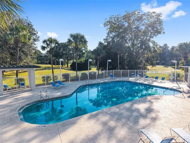 an aerial view of a house with swimming pool and lake view