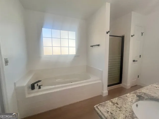 a bathroom with a bathtub and shower