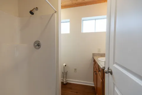 a view of hallway with wooden floor