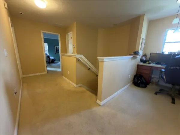 a view of a room with furniture and a window