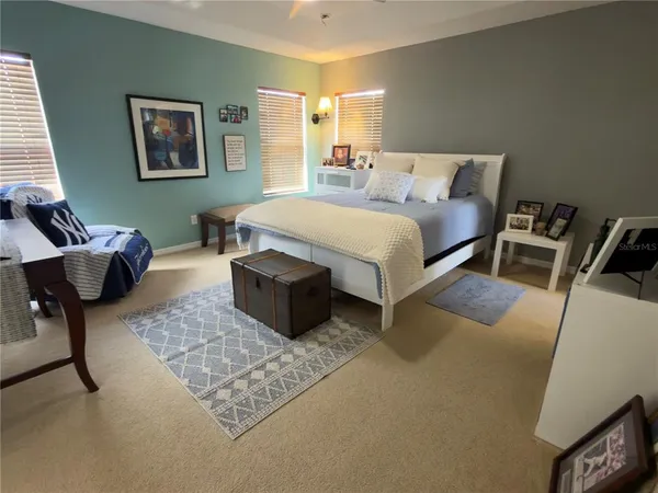 a bedroom with a bed and chair