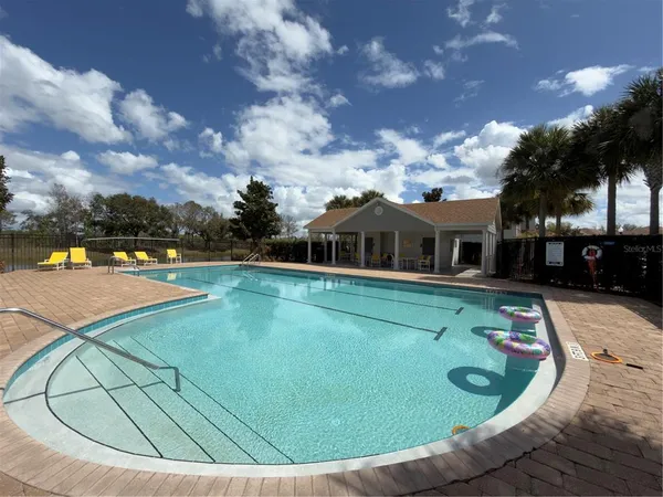 a view of a swimming pool with a yard