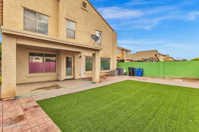 a view of a house with a yard and sitting area