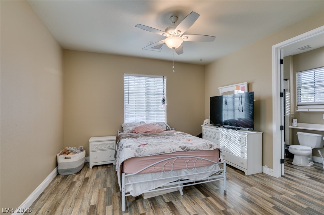 7524 Midnight Rambler Street Las Vegas, NV 89149 - Photo 32 of 51 A comfortable bedroom with rich wood flooring and a refreshing ceiling fan for climate control.