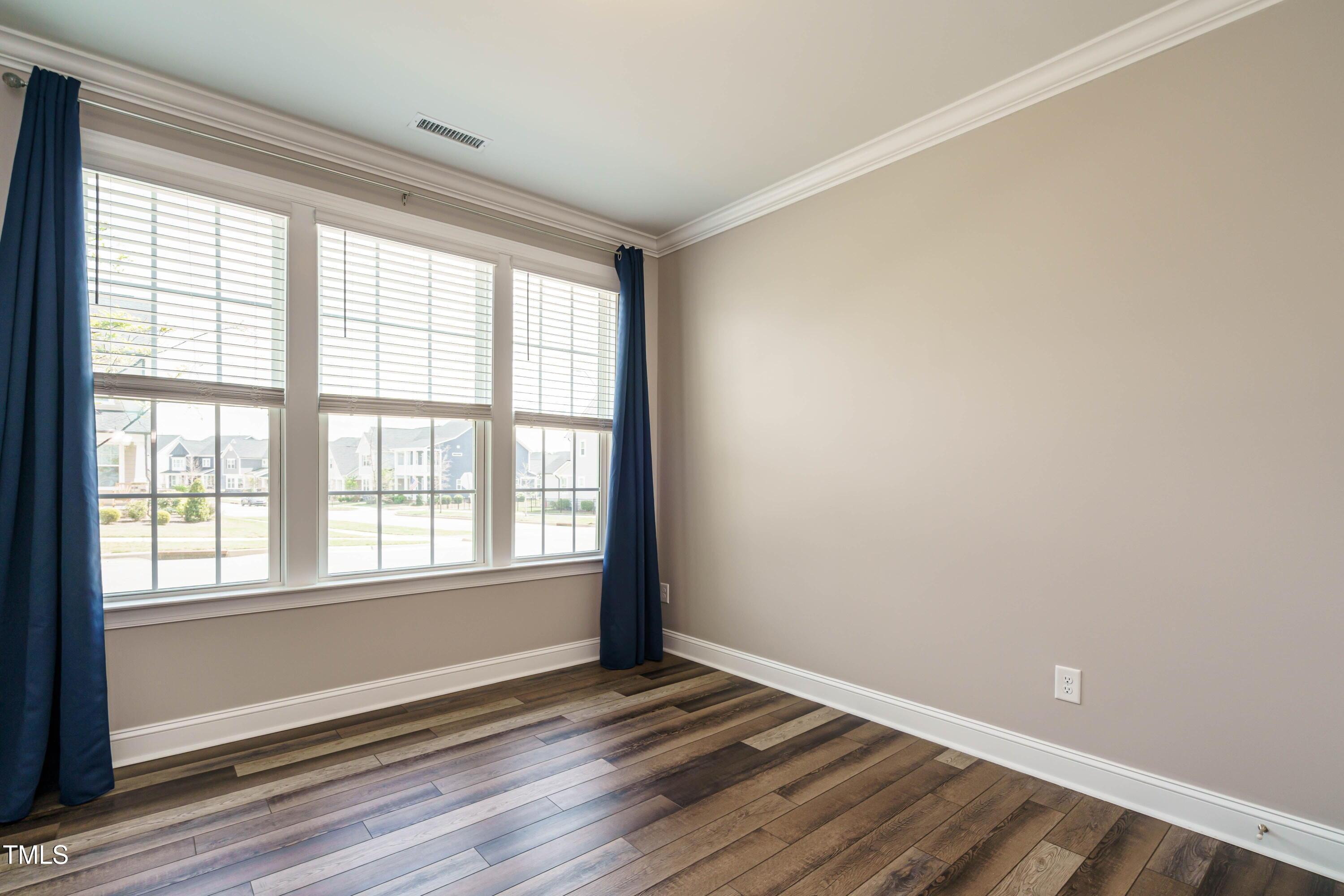 5201 Influence Way Raleigh, NC 27616 - Photo 18 of 33 a view of an empty room with wooden floor and a window