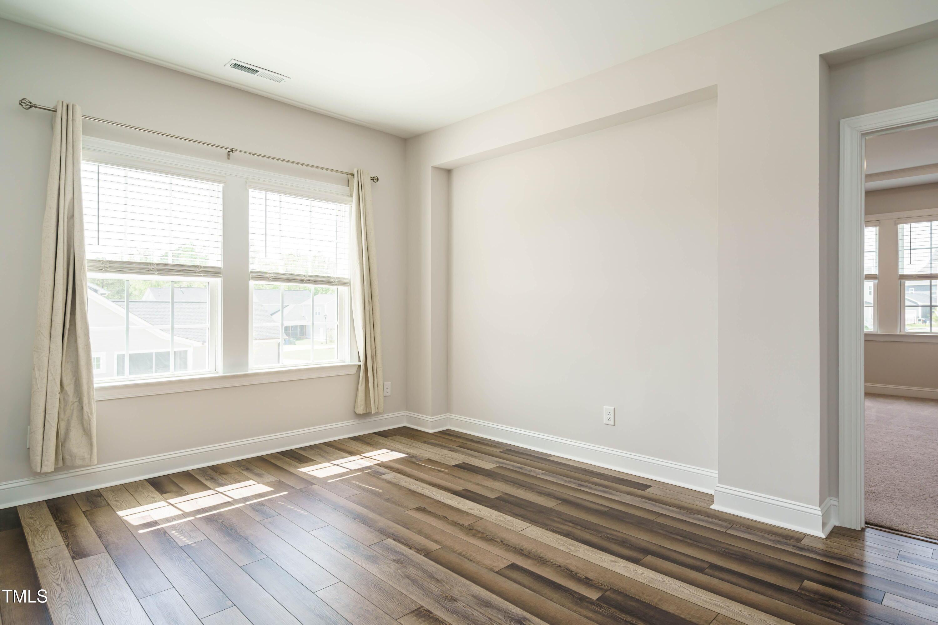 5201 Influence Way Raleigh, NC 27616 - Photo 20 of 33 an empty room with wooden floor and windows
