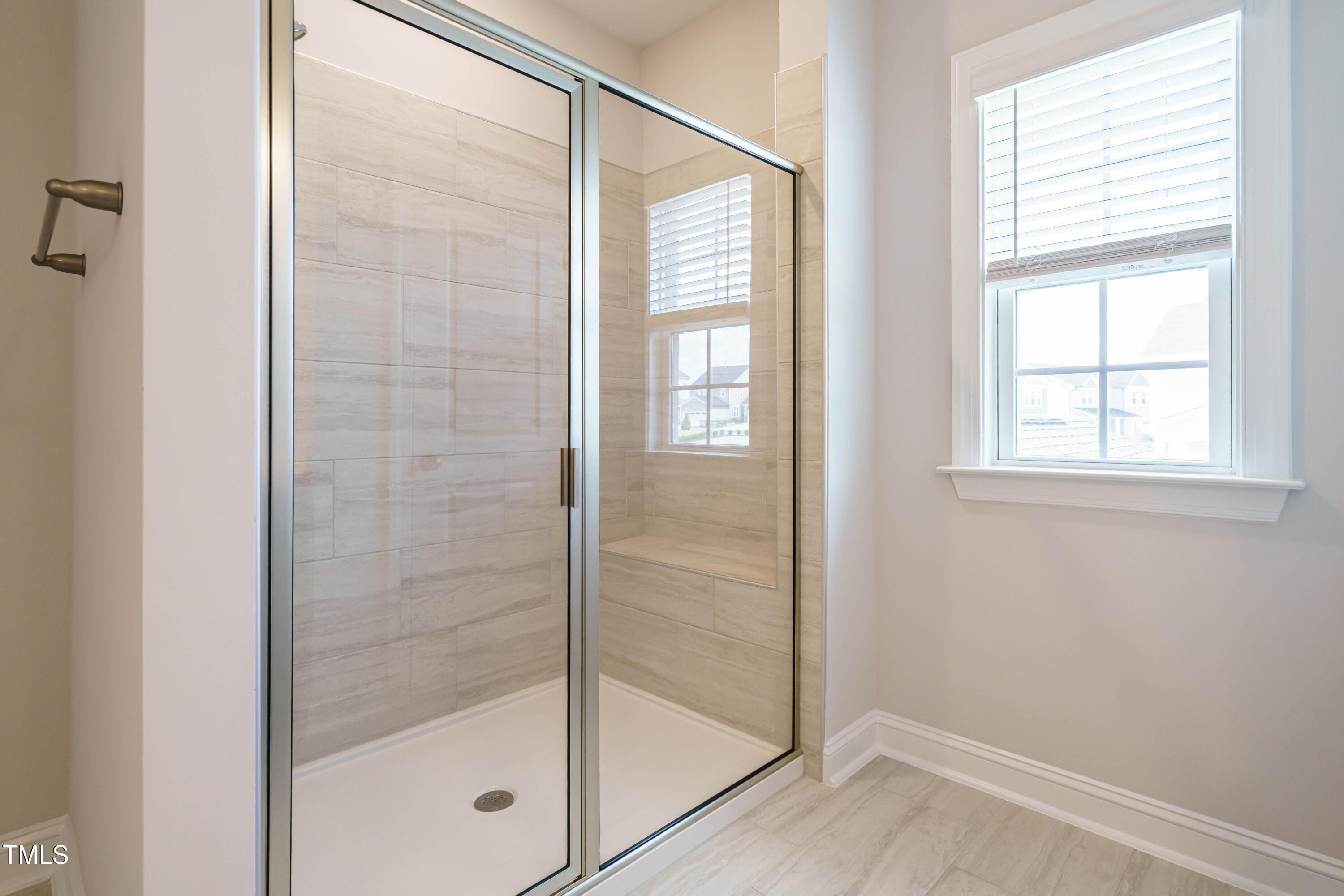 5201 Influence Way Raleigh, NC 27616 - Photo 26 of 33 a bathroom with a glass shower door