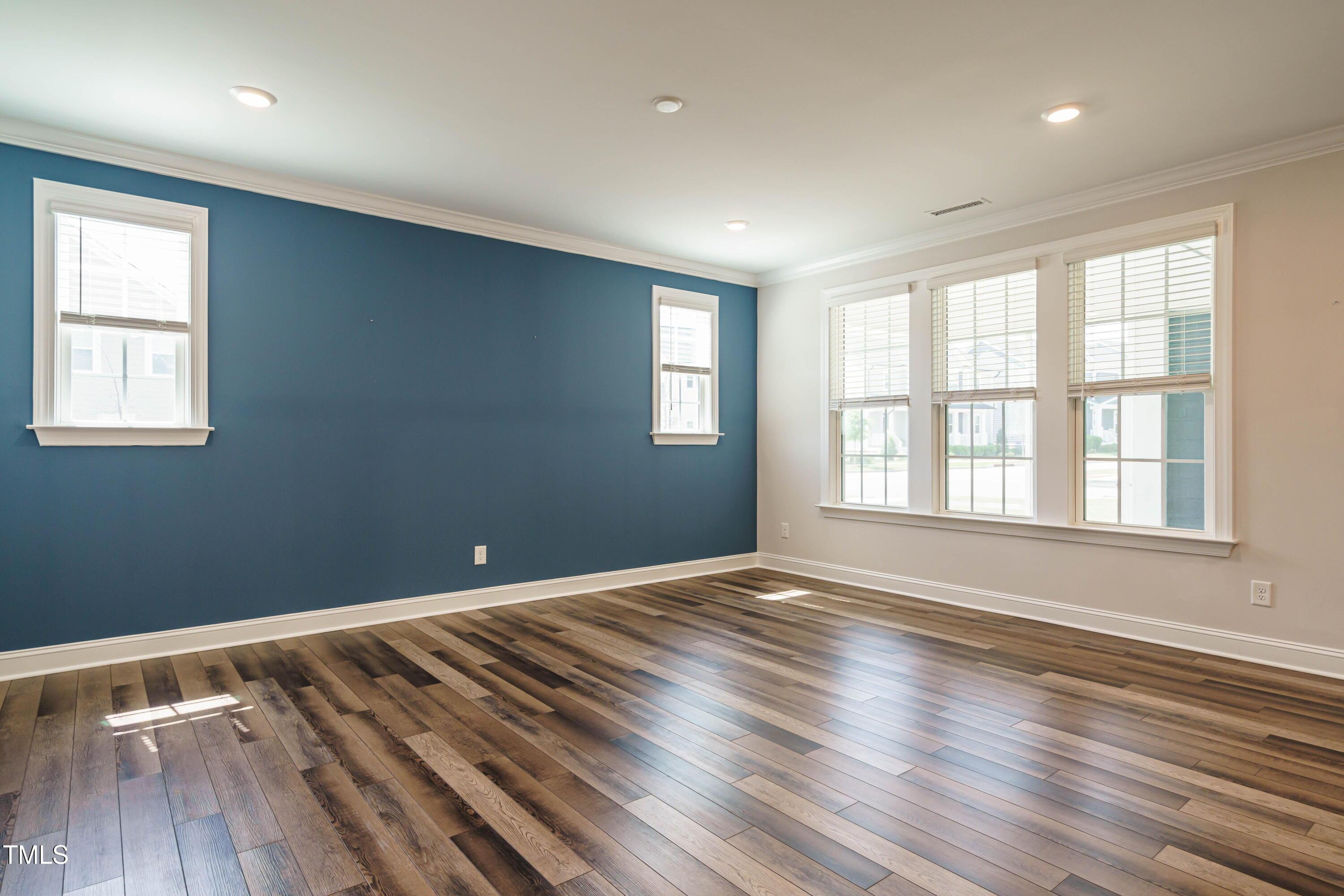 5201 Influence Way Raleigh, NC 27616 - Photo 6 of 33 a view of an empty room with wooden floor and a window