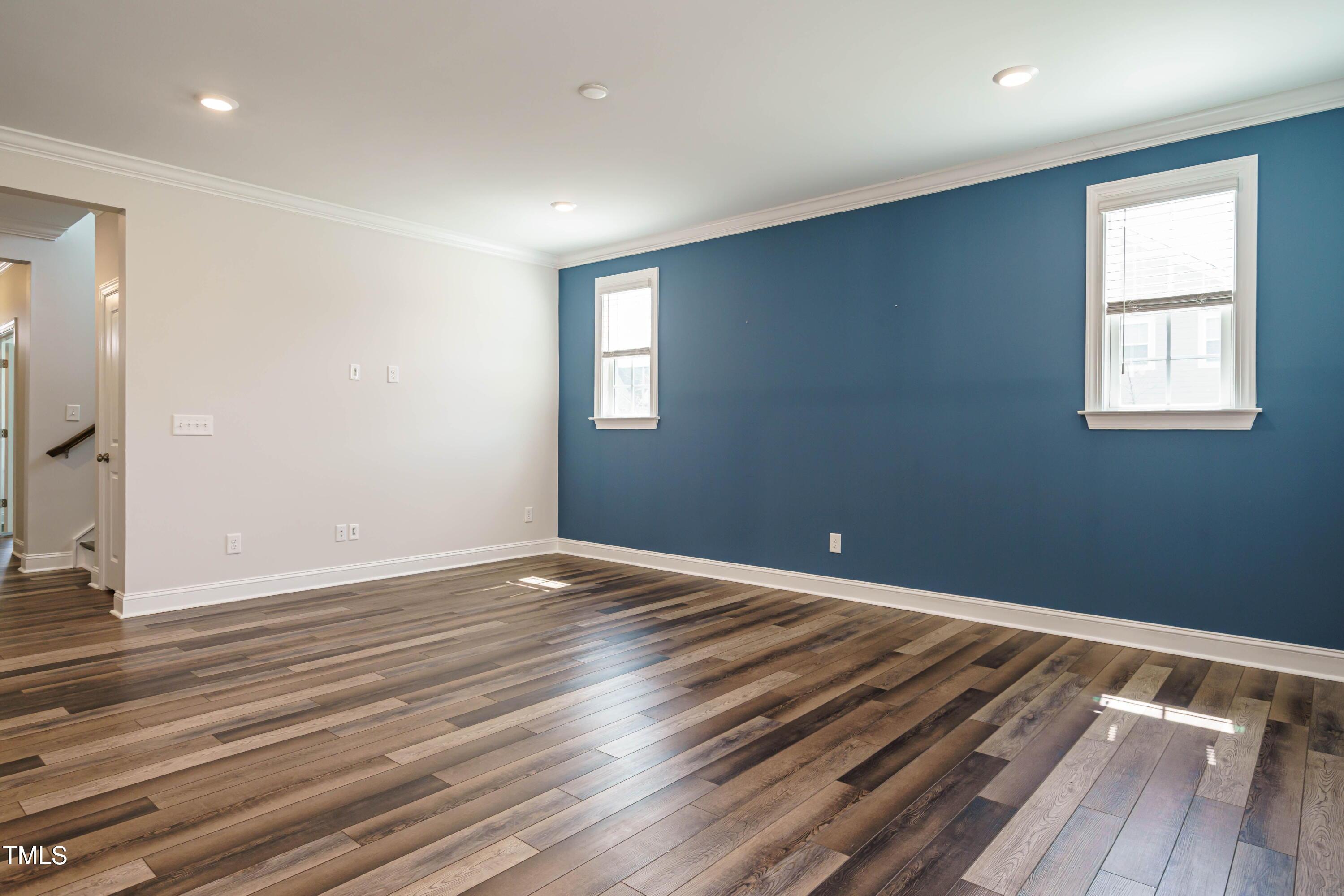 5201 Influence Way Raleigh, NC 27616 - Photo 8 of 33 a view of an empty room with wooden floor and a window