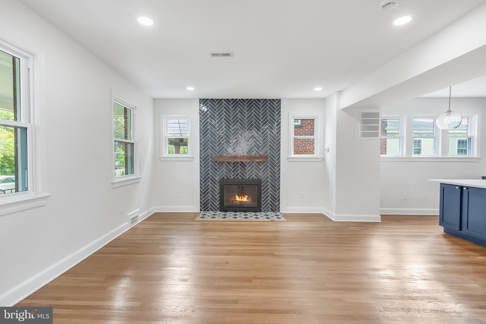 6932 8th Street Northwest Washington, DC 20012 - Photo 15 of 43 a view of an empty room with wooden floor fireplace and a window