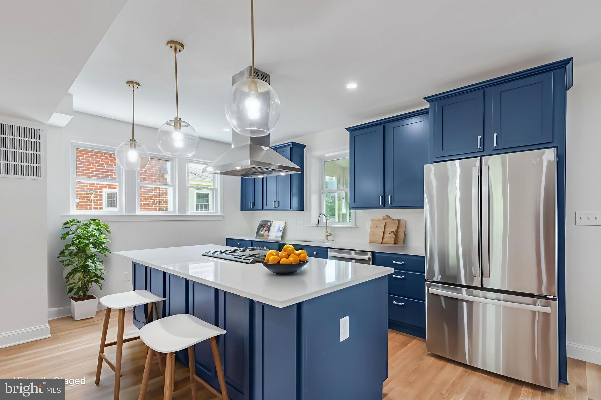 6932 8th Street Northwest Washington, DC 20012 - Photo 2 of 43 a kitchen with stainless steel appliances a refrigerator a sink a stove a dining table and chairs