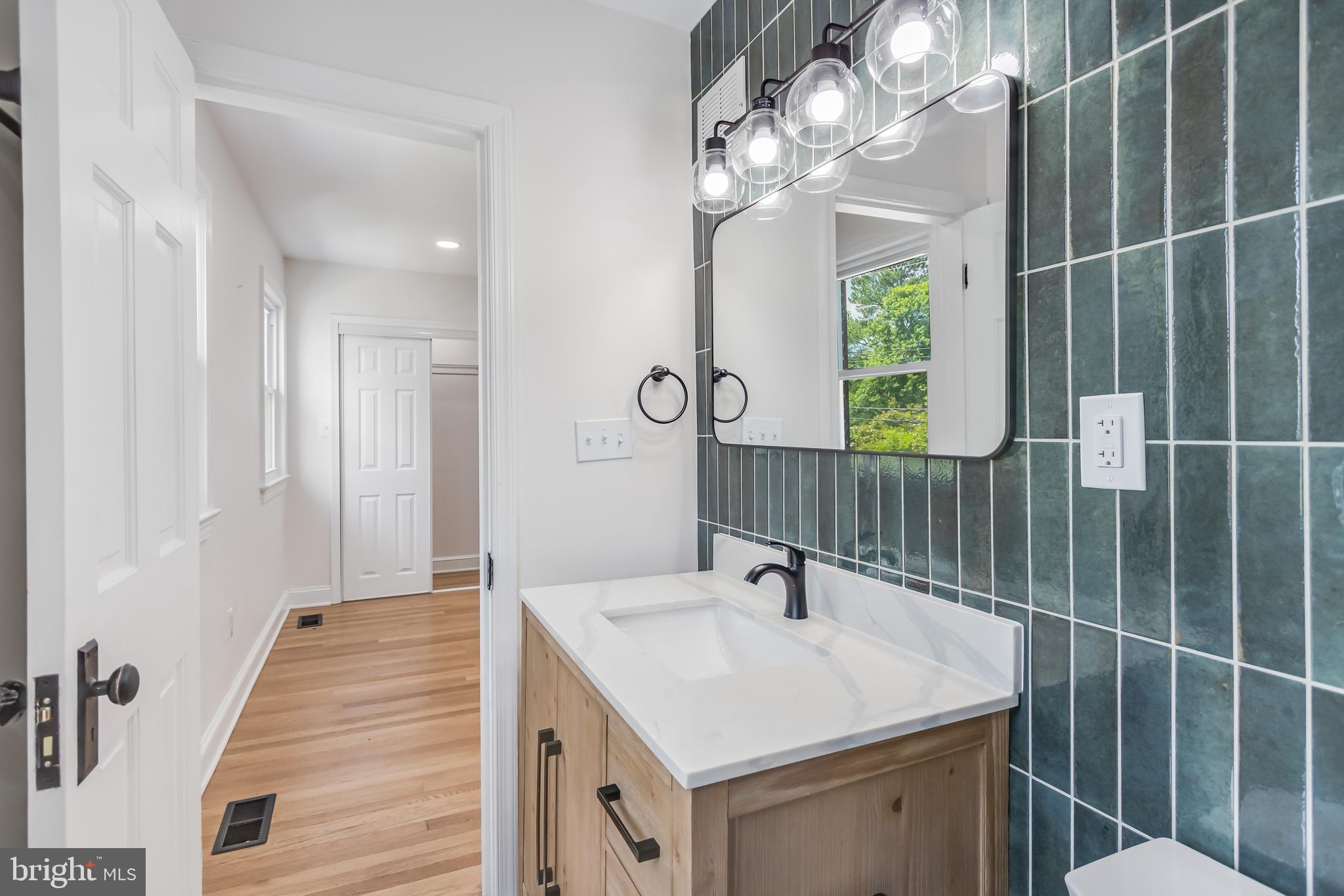 6932 8th Street Northwest Washington, DC 20012 - Photo 26 of 43 a bathroom with a sink a mirror and shower