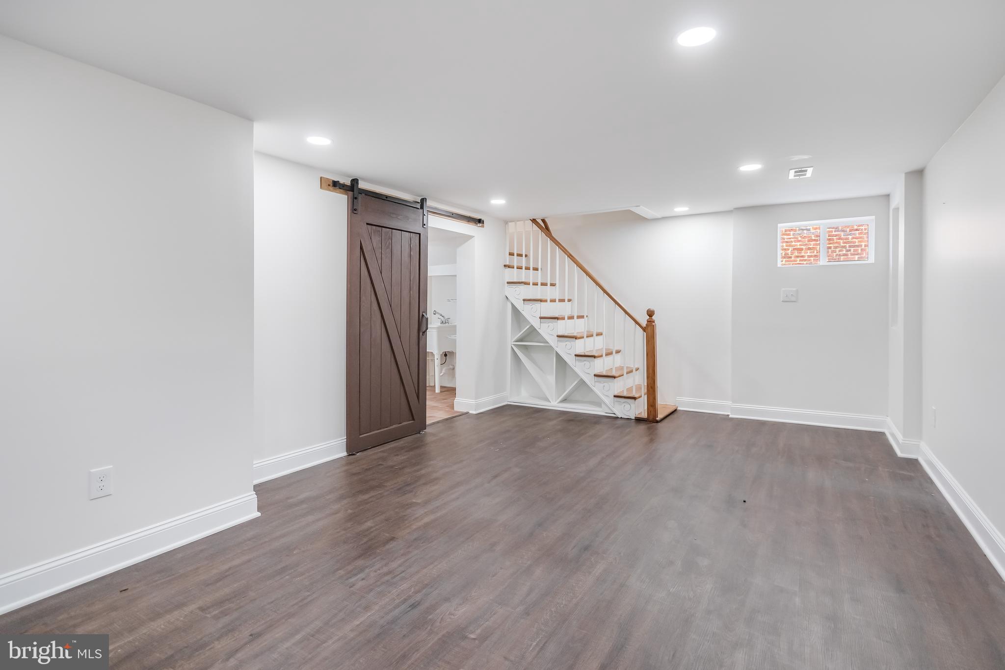 6932 8th Street Northwest Washington, DC 20012 - Photo 34 of 43 an empty room with wooden floor and stairs
