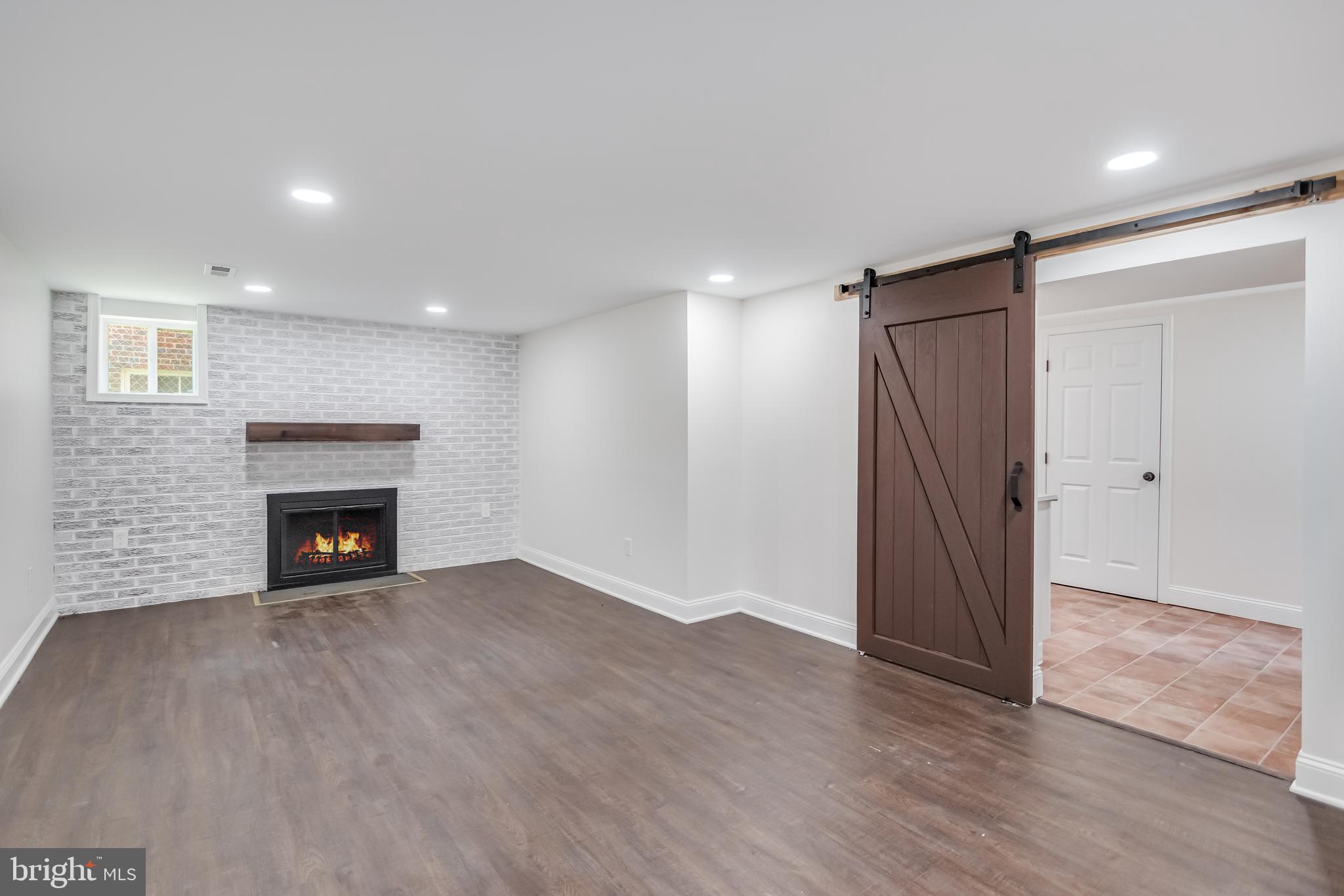 6932 8th Street Northwest Washington, DC 20012 - Photo 35 of 43 a view of an empty room with wooden floor fireplace and a window