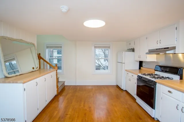 a kitchen with a stove a sink and a refrigerator