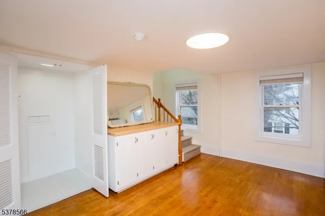 a view of a room with window and wooden floor