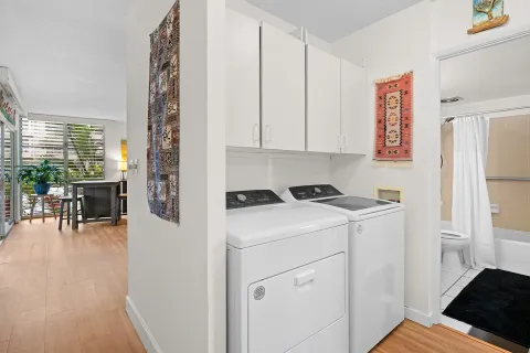 a view of washer and dryer with kitchen view