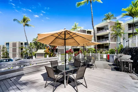 a view of a table and chairs under an umbrella in patio