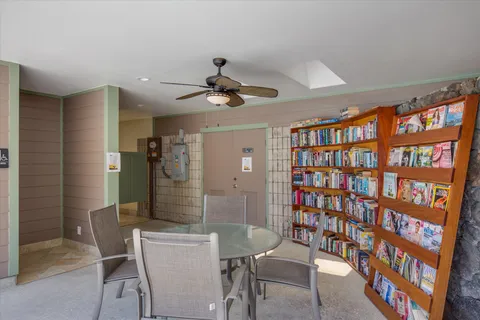a dining room with furniture and a book shelf