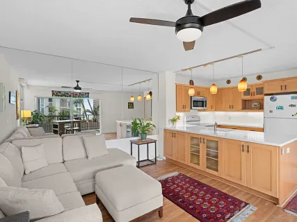 a living room with furniture and a chandelier
