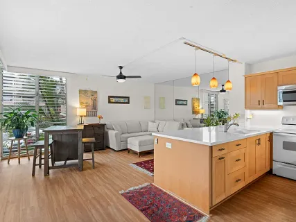 a living room with furniture and wooden floor